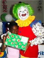 Annie the clown distributing Make Jesus Smile shoeboxes