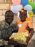 Pastor Anous Nordeus distirbuting the Make Jesus Smile shoeboxes to the children of the Maranatha school