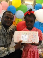 Pastor Anous Nordeus distirbuting the Make Jesus Smile shoeboxes to the children of the Maranatha school