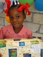 Seen here an orphan at the Maranatha Ministries Orphanage receiving her Christmas 2008 Make Jesus Smile shoebox thanks to Power in the Blood Sunday School class in Barbados.