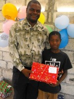 Pastor Anous Nordeus distirbuting the Make Jesus Smile shoeboxes to the orphans