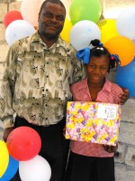 Seen here Pastor Anous Nordeus the founder of Maranatha Ministries distirbuting the Make Jesus Smile shoeboxes to the children of Maranatha school. 