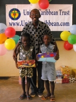 Pastor distributing the Make Jesus Smile shoeboxes in Brokoponda