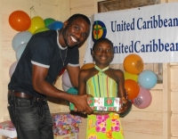 Imran Richards representing the Wesleyan Holiness church in Barbados seen here distributing the Make Jesus Smile shoeboxes.