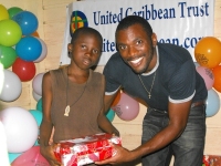 Imran Richards representing the Wesleyan Holiness church in Barbados seen here distributing the Make Jesus Smile shoeboxes.
