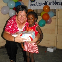 Kim Smith from Restoration Ministries in Barbados distributing the Make Jesus Smile shoeboxes to the Maroons in Tjaikondre.