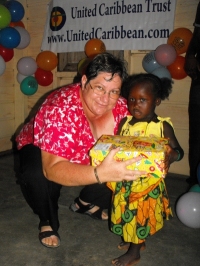 Kim Smith from Restoration Ministries in Barbados distributing the Make Jesus Smile shoeboxes to the Maroons in Tjaikondre.