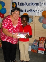 Kim Smith from Restoration Ministries in Barbados distributing the Make Jesus Smile shoeboxes to the Maroons in Tjaikondre.