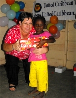 Kim Smith from Restoration Ministries in Barbados distributing the Make Jesus Smile shoeboxes to the Maroons in Tjaikondre.