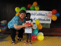 Kim Smith from Restoration Ministries in Barbados distributing the Make Jesus Smile shoeboxes to the Maroons in Victoria.