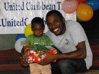 Imran Richards representing the Wesleyan Holiness church in Barbados seen here distributing the Make Jesus Smile shoeboxes.