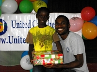 Imran Richards representing the Wesleyan Holiness church in Barbados seen here distributing the Make Jesus Smile shoeboxes.