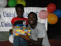 Imran Richards representing the Wesleyan Holiness church in Barbados seen here distributing the Make Jesus Smile shoeboxes.