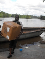 Seen here the Make Jesus Smile shoeboxes being transported up the Suriname River and arriving at Tjaikondre.