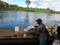 Seen here the Make Jesus Smile shoeboxes being transported up the Suriname River and arriving at Tjaikondre.