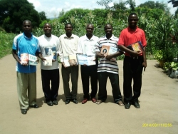 Bishop David Akondowe, senior Pastor at House of Freedom Church, Mbeya with other Pastors in A.T.B.S with a shipment of books donated to the ministry,