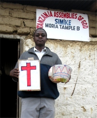Gwalughano Mwalusamba outside the Tanzania Simike Assembles of God church