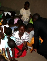 Pastor Abraham on his follow up visit to Bugire is seen here taking the children into the Holy of Holies. 