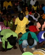 Pastor Abraham on his follow up visit to Bugire is seen here taking the children into the Holy of Holies. 