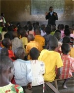 Pastor Abraham giving a KIMI PowerClub demonstration as part of the follow up programme organized by the KIMI Co ordinator