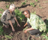 Seen here Jenny Tryhane, Founder of UCT  with Pastor Abraham, the Uganda UCT Representative planting a memorial Avocada tree on the boundary of the land.