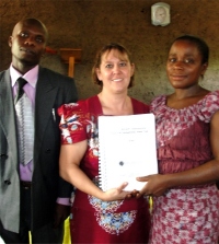Seen here with his wife receiving his KIMI curriculum and manual from Pastor Laura the KIMI Africa Representative.