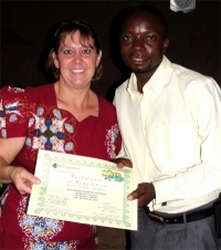 Seen here with Pastor Laura the KIMI Africa Representative receiving his KIMI certificate after receiving his training.