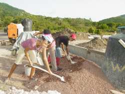 Seen here local members working with  a volunteer from Barbados