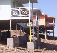 The galvanized steel support columns are embedded in concrete-filled foundation holes that can be hand excavated.