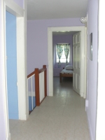 Top floor corridor connecting the three bedrooms.