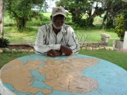 Rev. O'Brien Waithe  sitting at the Africa Prayer Station.